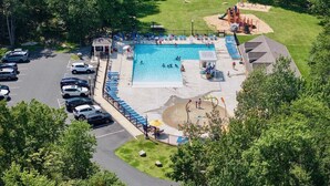 An aerial view of a swimming pool area with a pavilion, lounge chairs, and a playground. - Hot Tub ~ Luxury Landing (Tobyhanna)