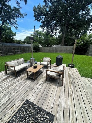 A wooden deck with outdoor furniture, including a sofa, chairs, and a table. - Pet friendly High Point Terrace Gem-Backyard Oasis (Memphis)