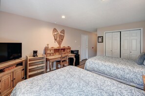 A bedroom with two beds, a TV, a wooden desk, and a wardrobe. - Pet Friendly Hotel Room in Central Copper MTN! (Frisco)