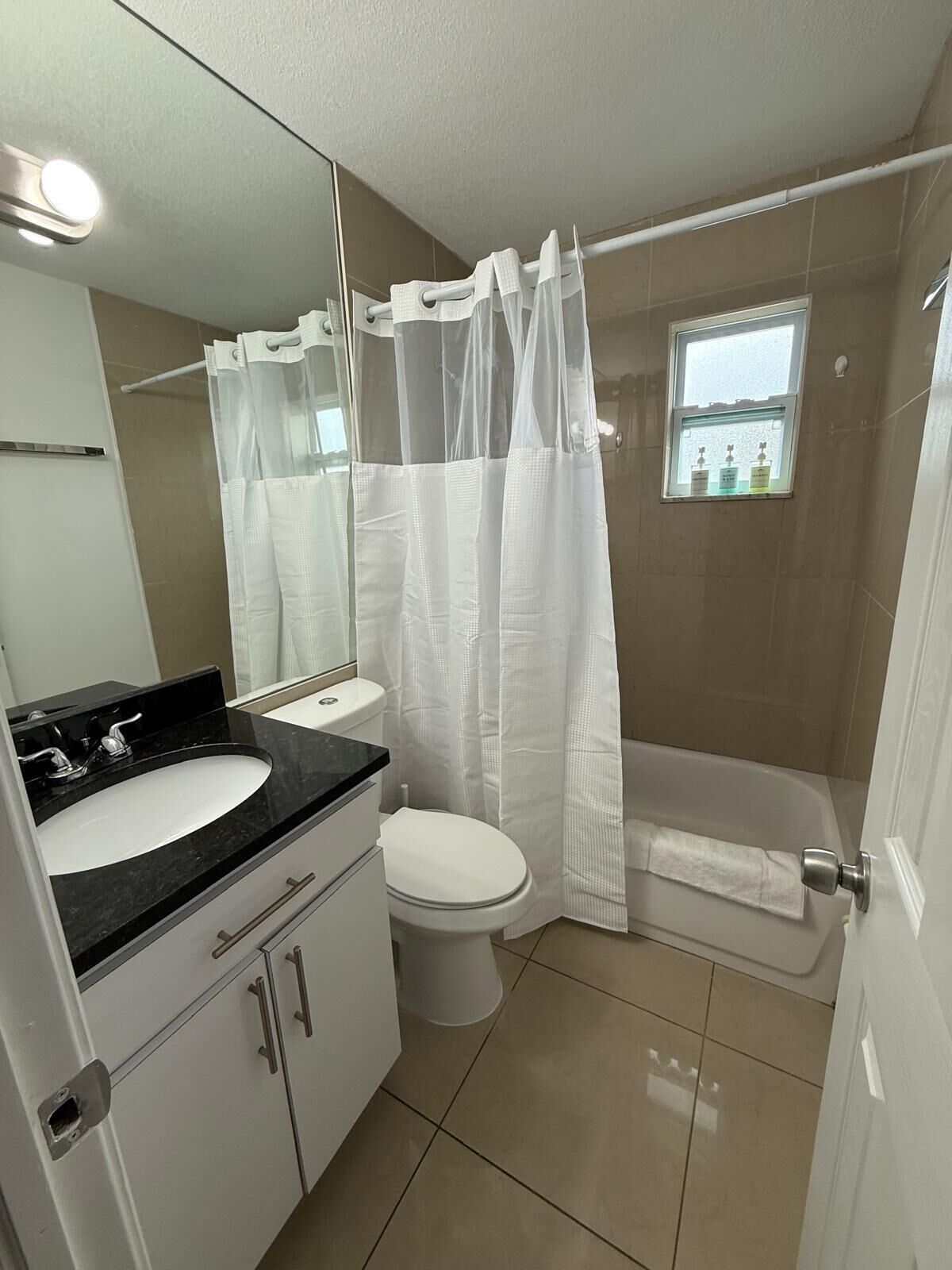 A bathroom with a sink, toilet, and bathtub.
