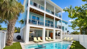A two-story building with a swimming pool, outdoor seating, and a covered patio area. - Cabana Club · 4 Kings · 3 Min Beach (Fort Myers Beach)