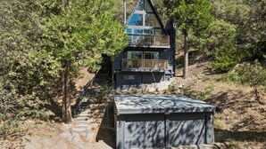A cabin with a balcony, surrounded by trees, and a small shed in front. - 3BR retreat w/ fireplace & BBQ grill (Lake Arrowhead)