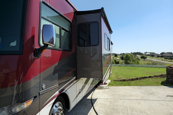 RV site with slide-out coach on a level pad and sweeping country views