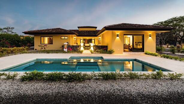 A two-story house with a swimming pool, a patio, and a well-maintained garden. - Casa Quetzal, a charming tropical retreat in Hacienda Pinilla Beach Resort (Santa Cruz)