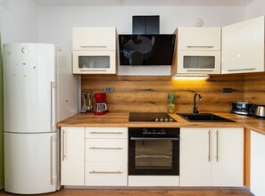 A compact kitchen with a refrigerator, microwave, stove, oven, and sink. - Comfort Two Bedroom Apartment (Pero) (Ploce)