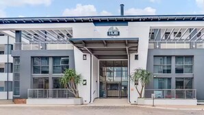A modern building with a sign reading 'The HUB BRYANSTON' at the entrance. - The Hub Serviced Apts, Bryston Backup Power Wifi (Johannesburg)