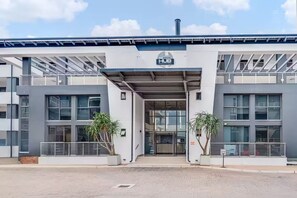 A modern building with a sign reading 'The HUB BRYANSTON' at the entrance. - The Hub Serviced Apts, Bryston Backup Power Wifi (Johannesburg)