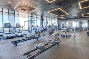 A gym with treadmills, stationary bikes, and weight machines. - Central Studio Apt with Restaurant, Gym & Sauna (Johannesburg)
