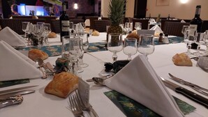 A dining table set with wine glasses, plates, cutlery, and bread. - L Espérance  (Vitré)