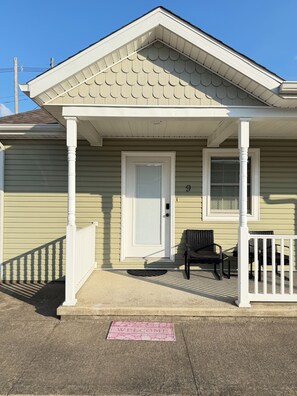 A house with a porch, a door, and a mailbox.