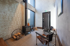 A modern interior with a fireplace, seating area, and a door with an exit sign.