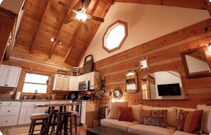 A cabin interior with a kitchen, dining area, and living room. - Lovely private 2-bedroom cabin near river (Marshall)