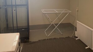A room with a window, a radiator, and a metal drying rack. - Apartment downstairs in my house. Short walking distance to commuter train. (Stockholm)