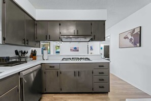 A modern kitchen with stainless steel appliances, a dishwasher, and a gas stove. - Austin Retreat with Private Pool l Mins to Downtown! (Austin)