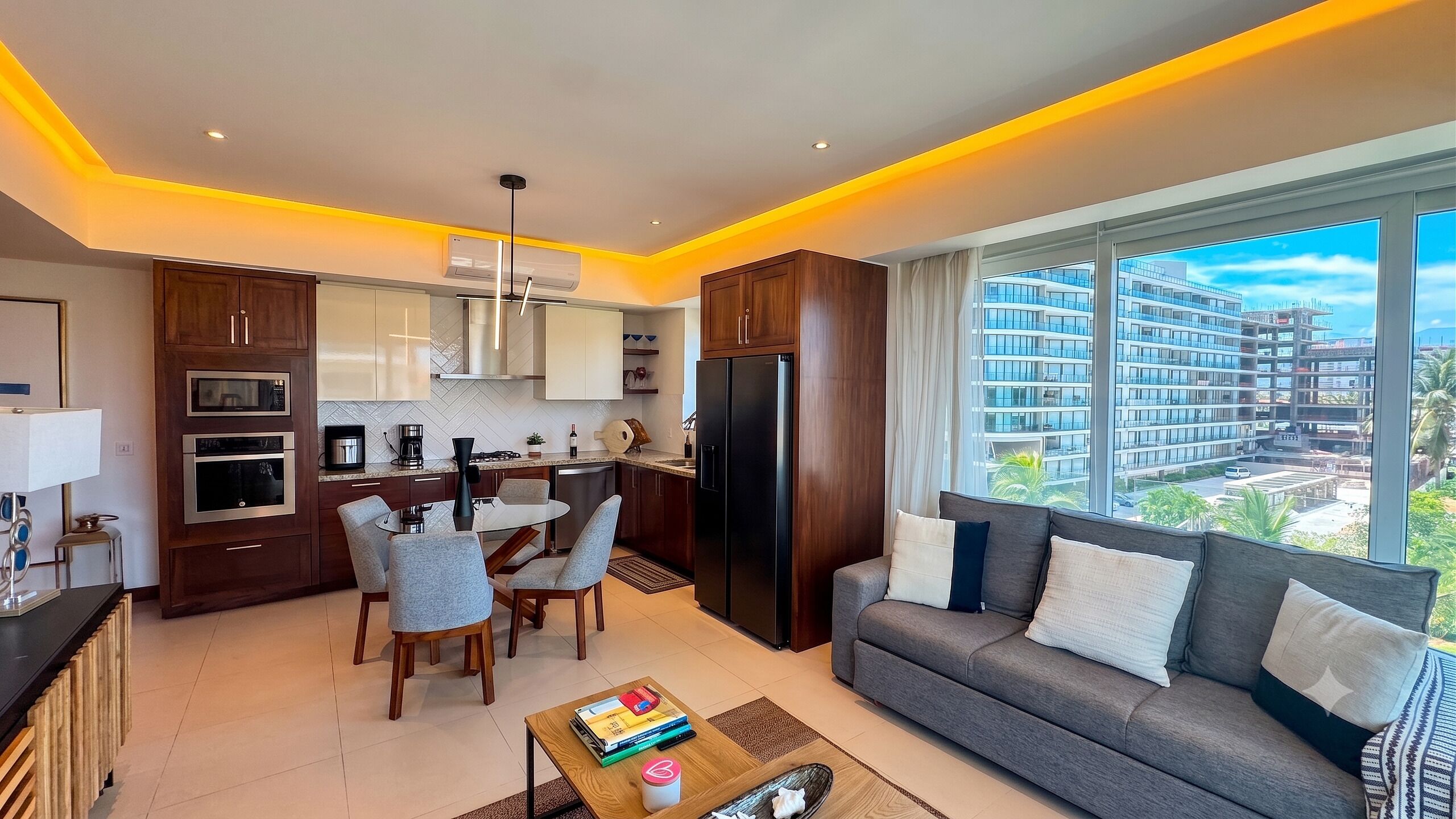 A modern apartment with a kitchen, dining area, and living room.