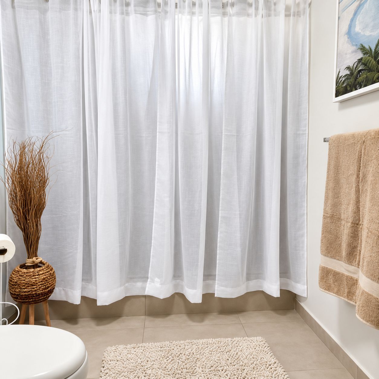A bathroom with a white shower curtain, a beige rug, a white toilet, and a wall-mounted towel rack with a towel.