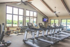 A gym with treadmills, dumbbells, and a TV screen. - Aspen Peak Chalet | Lake Aspen, Foliage, Fire Pit (Innsbrook)