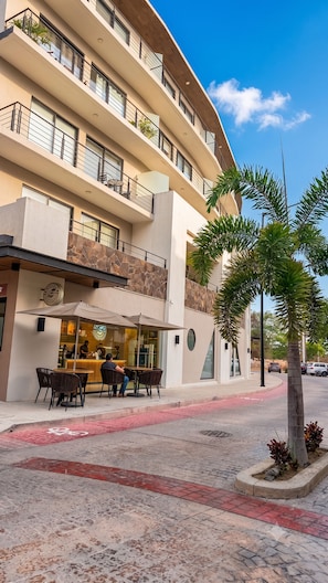 A multi-story hotel with outdoor seating, a restaurant, and a palm tree. - LUX 2-Storie 3-BDR 3.5 Bath Penthouse (Puerto Vallarta)