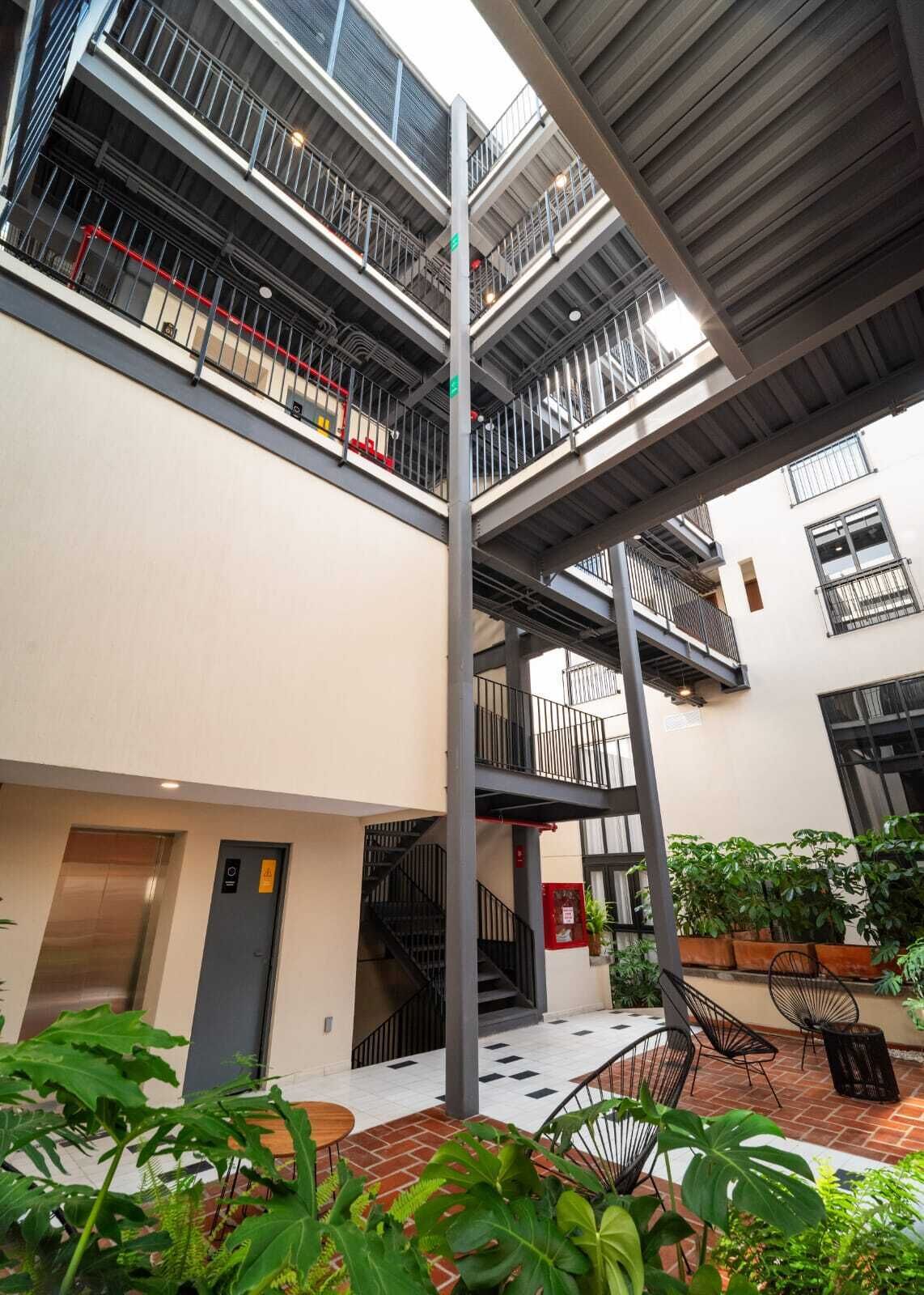 A multi-level building with outdoor seating and a staircase.