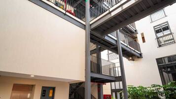 A multi-level building with outdoor seating and a staircase.