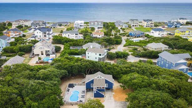 A residential area with houses, a swimming pool, and a view of the ocean. - Coastal Getaway with Pool, Spa, Direct Beach Path! (Southern Shores)