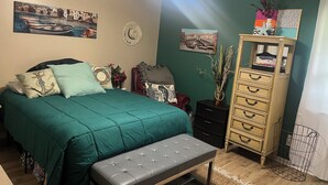 A bedroom with a bed, a bench, a dresser, and a ceiling fan. - 3/2 house in Statesboro with nearby GA Southern and Savannah (Statesboro)
