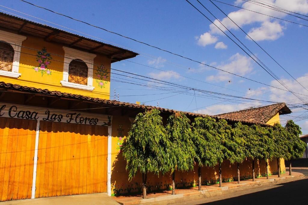 A yellow building with a sign reading 'Casa Las Flores.'