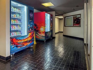 A hallway with vending machines and a push cart. - Central Waikiki 2 Bedroom, AC, Lanai, Pool, King (Honolulu)