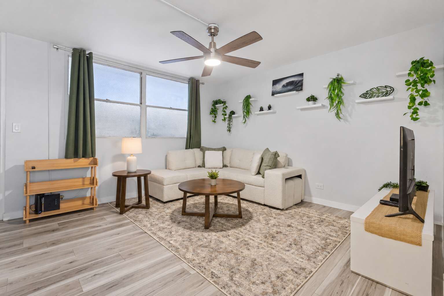 A living room with a sofa, coffee table, and a TV stand.