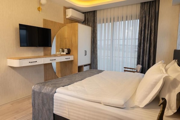 Comfort Room, Garden View | In-room safe, desk, laptop workspace, soundproofing - New City Otel (Osmaniye)