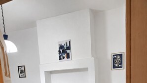 A hotel room with two beds, a desk, and a white wall with artwork. - Skip for now (Manchester)