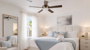 A bedroom with a bed, bedside tables, a chair, a ceiling fan, and a painting on the wall. - Day Dreams Begin at Bryant Denny Stadium 6 ppl (Tuscaloosa)