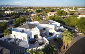 A modern multi-story house with a spacious outdoor patio area, multiple air conditioning units, and a view of the surrounding neighborhood. - Lyra - Dual Retreat - In Old Town Scottsdale (Scottsdale)