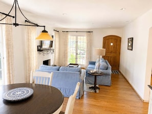A living room with a sofa set, a dining table, and a lamp. - New! Casa Capricho in West Beach with A/C, private yard, walk to beach (Santa Barbara)