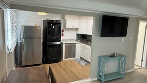 A modern kitchen with a built-in oven, a refrigerator, and a dishwasher.
