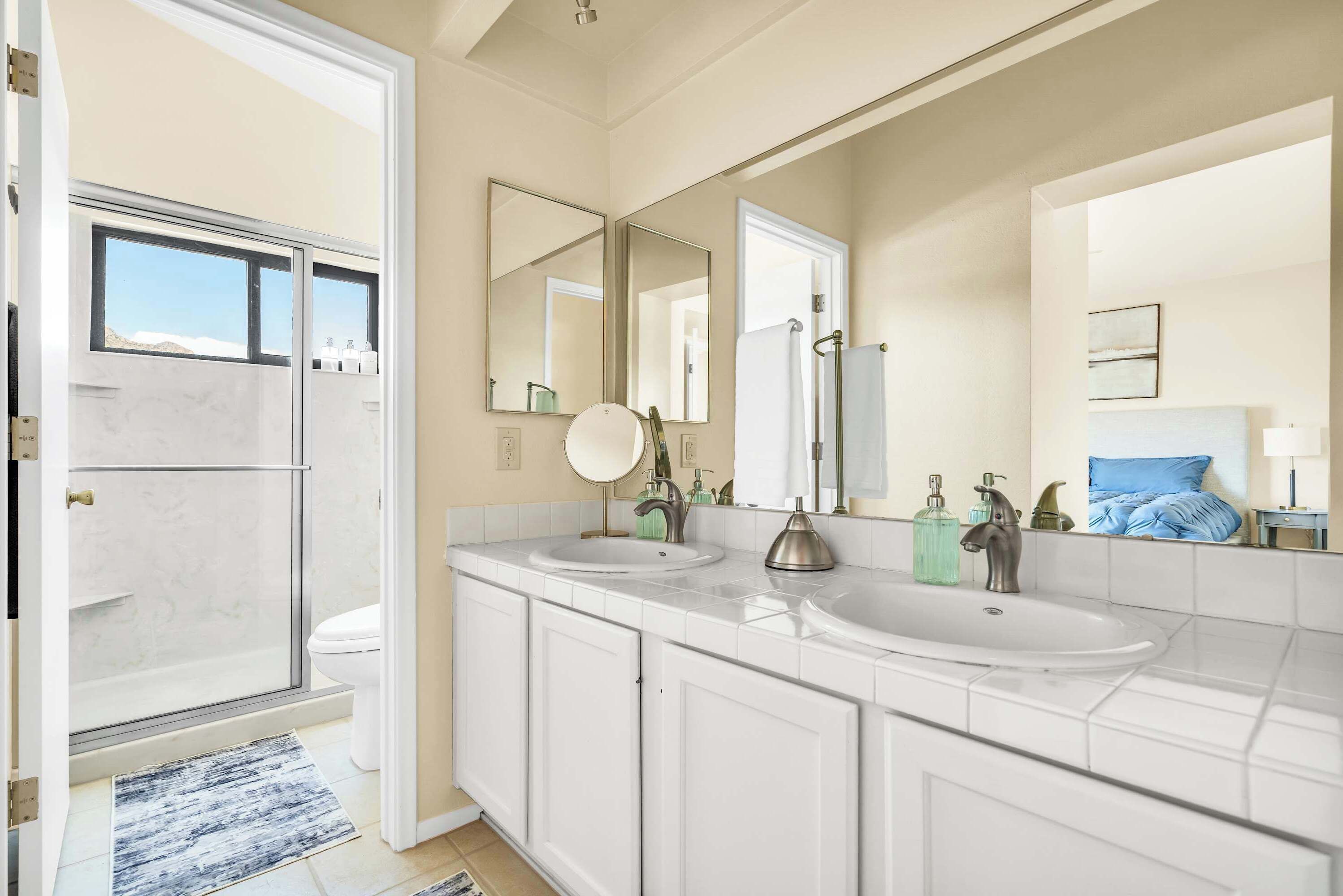 Spacious Primary Ensuite
Freshen up in the bright primary ensuite featuring a double-sink vanity, plenty of counter space, and direct access to the walk-in shower.