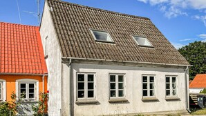 A two-story building with a sloped roof, multiple windows, and a visible antenna. - Amazing home in søby ærø with WiFi (Søby Ærø)