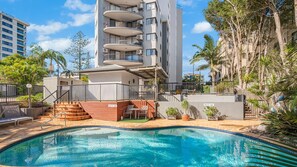 A modern hotel with a pool, outdoor seating, and a view of the surrounding buildings. - Meridian unit 15 Kings Beach (Kings Beach)