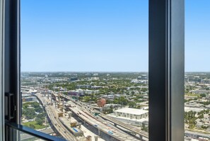 A high-rise building with a view of a cityscape, including roads and buildings. - Deluxe E11EVEN Suite with Elite Amenities (Miami)