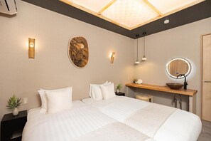 A modern hotel room with a large bed, bedside tables, a vanity with a mirror, and a ceiling light fixture. - JAPAVISTA Yumeno (BAIKA, KONOHANA WARD)