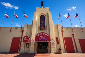 A building with a sign reading 'BILLY BOB'S TEXAS' and multiple flags. - Budget-Friendly Stay Close to Sundance Square - 2.4 miles (Fort Worth)