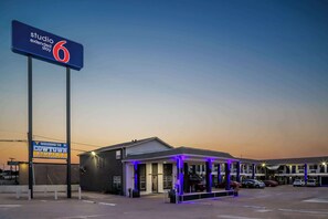 A motel with a sign reading 'Studio 6 Extended Stay' and a 'Welcome to Cowtown' sign. - Classic Quad Room | Downtown, 1.5 mi Stockyards Station, 1.6 mi to Rodeo (Fort Worth)