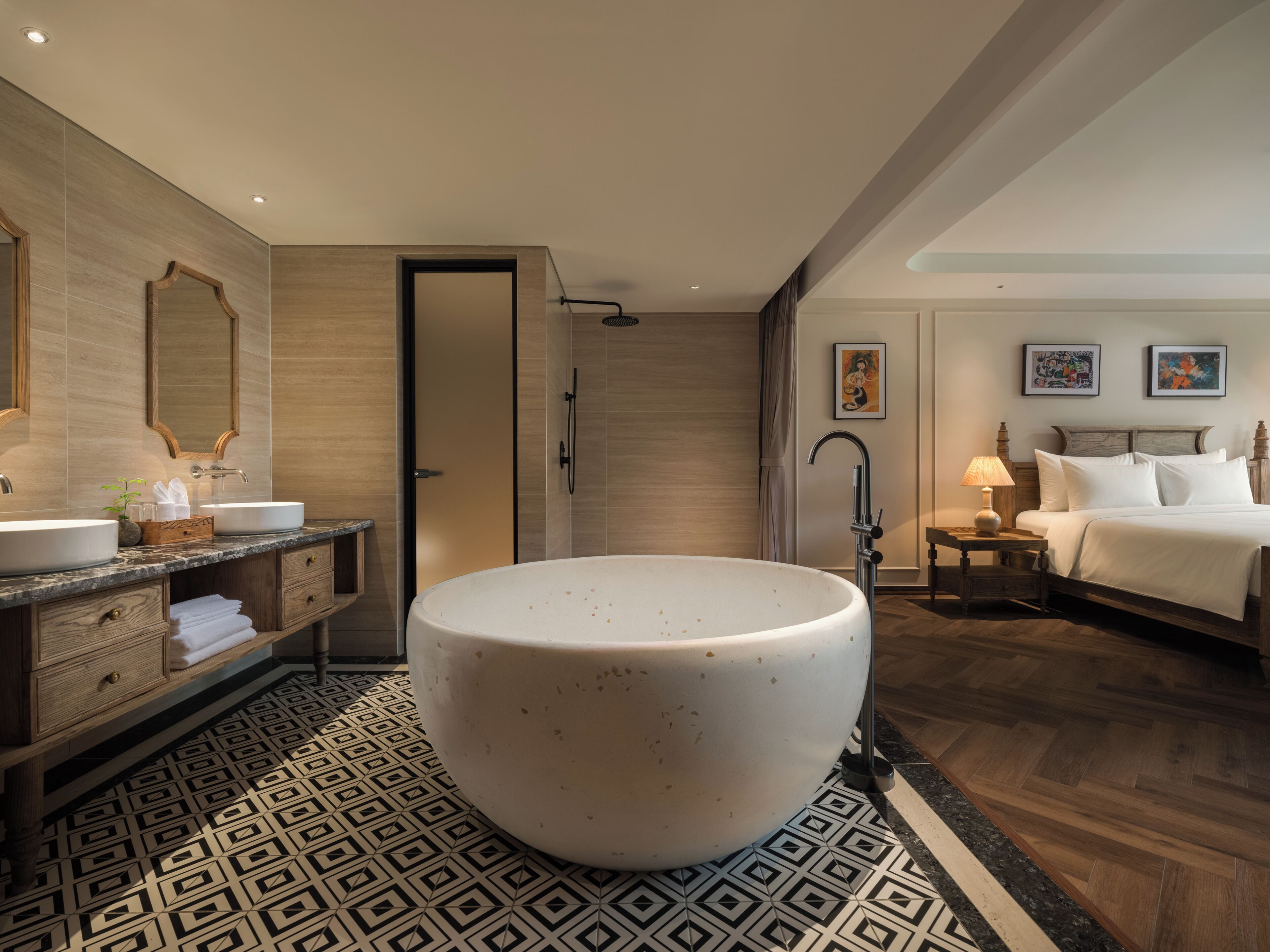 A modern bathroom with a freestanding bathtub, a vanity with a mirror, and a shower area.