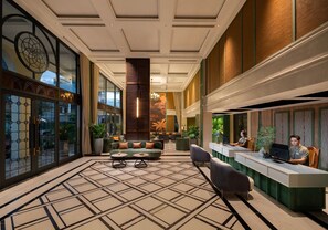 A spacious lobby with a reception desk, seating area, and large windows. - Hotel LaVue Tam Coc (Nam Hoa Lu)
