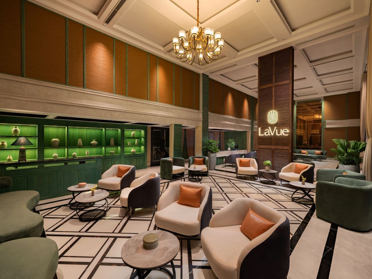 A hotel lobby with seating areas, a chandelier, and a 'LaVue' sign.