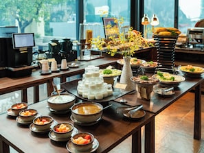 A buffet table with various food items and a coffee station. - Hotel LaVue Tam Coc (Nam Hoa Lu)
