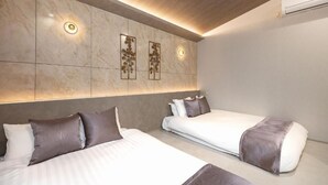 A hotel room with two beds, a marble wall, and a ceiling light. - JAPAVISTA Luminous (SHIMANOUCHI, CHUO WARD)