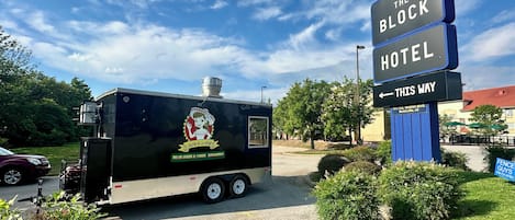 A food truck with a sign for 'The Block Hotel' and a directional arrow pointing left.