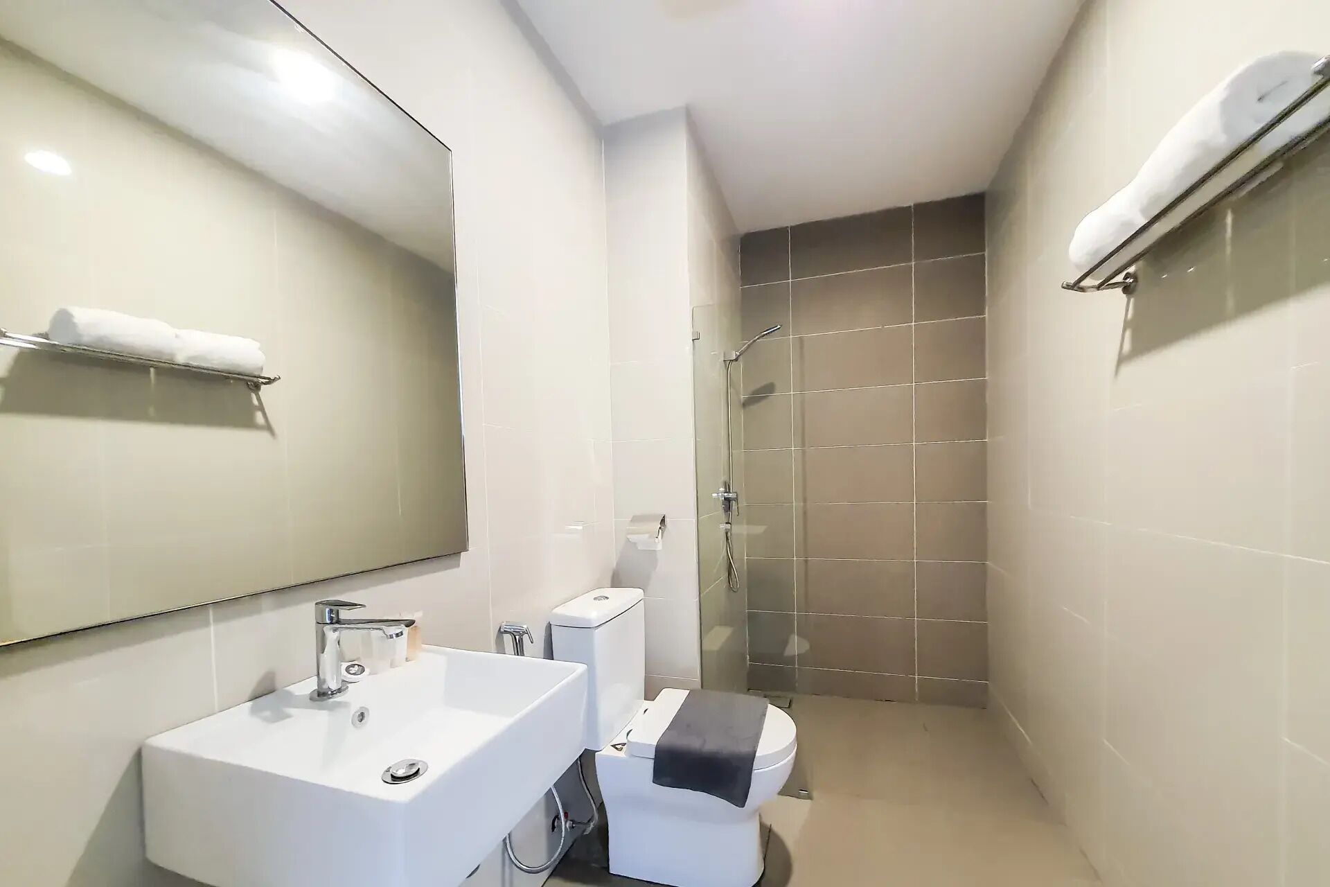 A bathroom with a white sink, toilet, and shower.