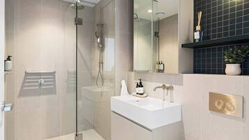 Shower, hair dryer, towels, shampoo